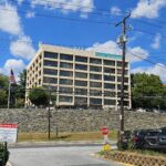 White building with large windows on hill behind retaining wall located at 10750 Columbia Pike Silver Spring, MD 20901